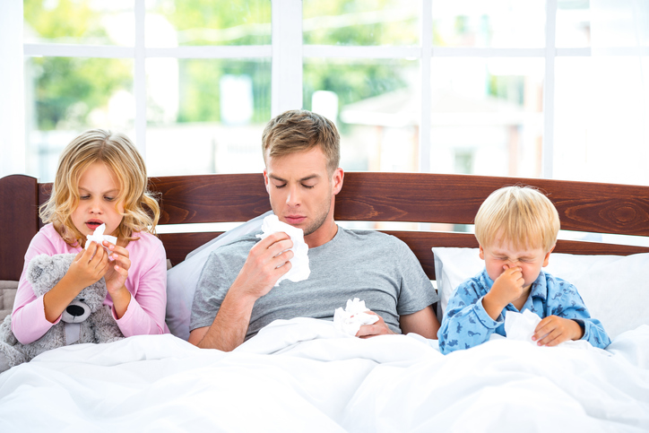 Uma forma infecciosa da constipação comum afecta toda a família Fonte da foto: Getty Images A constipação infecciosa é altamente contagiosa, família na cama, pai e filhos