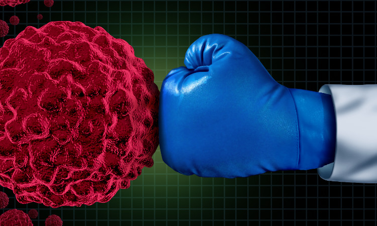 Fonte: Getty Images um murro com uma luva de boxe azul numa célula tumoral