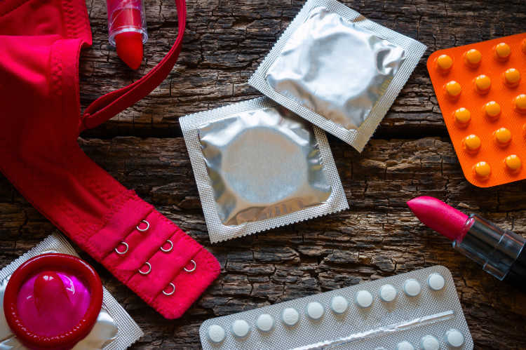 Medidas preventivas contra doenças sexualmente transmissíveis e gravidez indesejada: Getty Images preservativos, sutiã e batom na casca de uma árvore