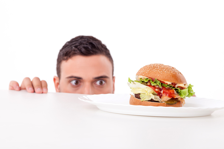Stress, carga de trabalho, psique Fonte: thinkstock photos O homem tem apetite, há um hambúrguer no seu prato