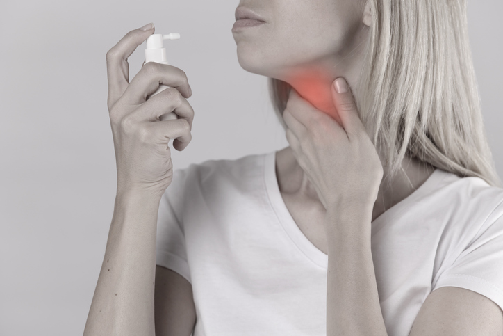 Mulher com dor de garganta, inflamação, amigdalite, spray para tratamento tópico